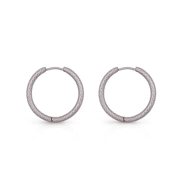 Subtle hoop earrings with coiled texture – balancing dimension and elegance.