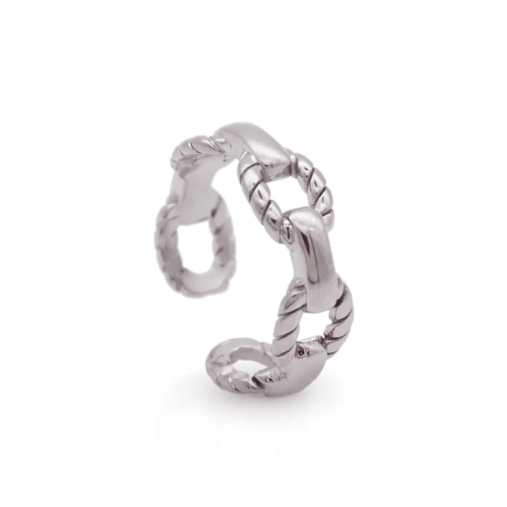 Chunky silver ring with linked anchor-style details – symbolising stability and sculptural presence.