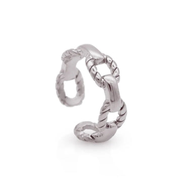 Chunky silver ring with linked anchor-style details – symbolising stability and sculptural presence.