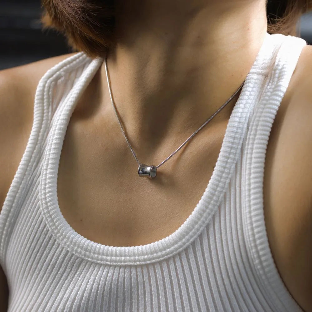 Model wearing faceted gemstone necklace – reflecting clarity, elegance, and elevated daily wear.