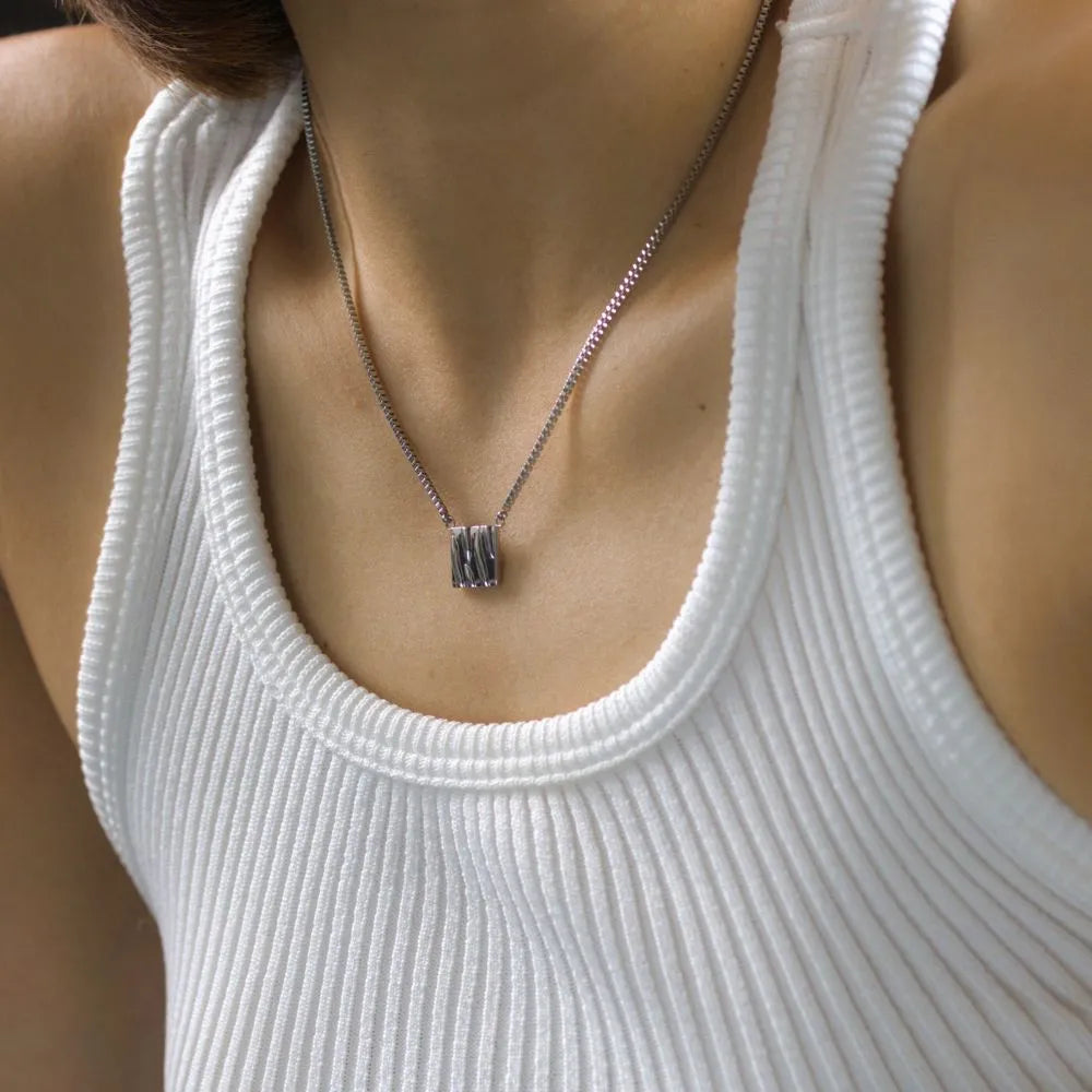 Rectangle pendant necklace with a ripple texture – reflecting movement, water, and calm energy.