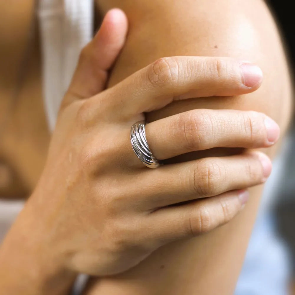 Smooth band ring with flowing grooves – designed to mirror current, ease, and intuitive momentum.