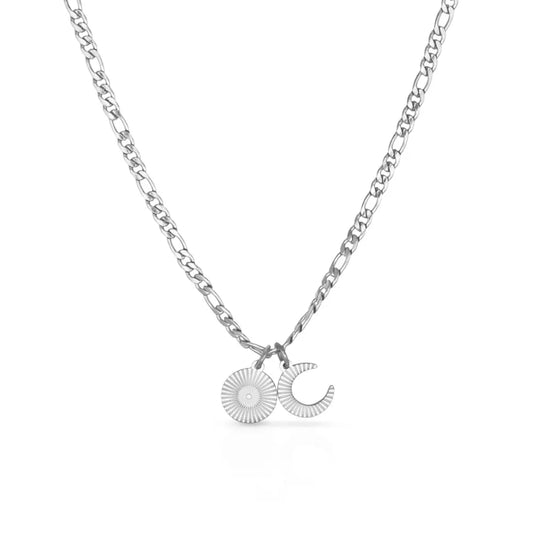 Celestial necklace with sun and moon charms – representing rhythm, intention, and inner light.
