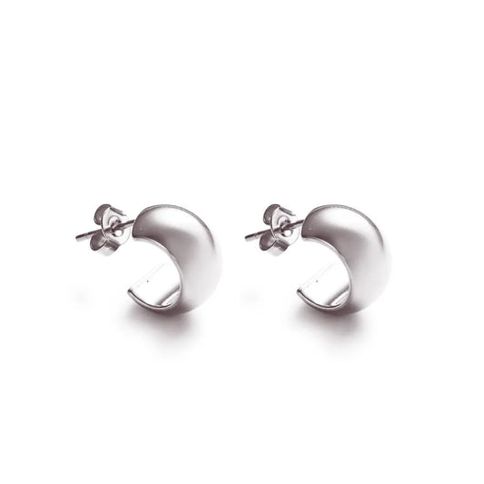 Curved silver stud earrings – a bold, minimal expression of presence and form.