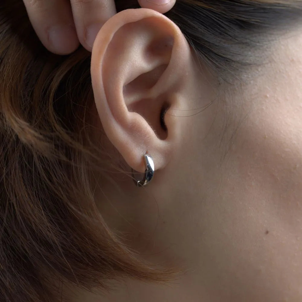 Polished silver Halo Mini hoop earrings – minimal and durable, crafted for movement and everyday styling.