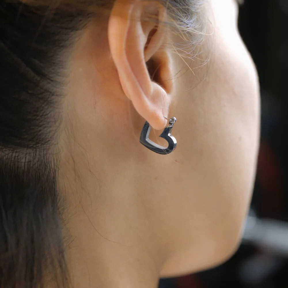 Polished heart-shaped hoops – balancing emotion, clarity, and connection.
