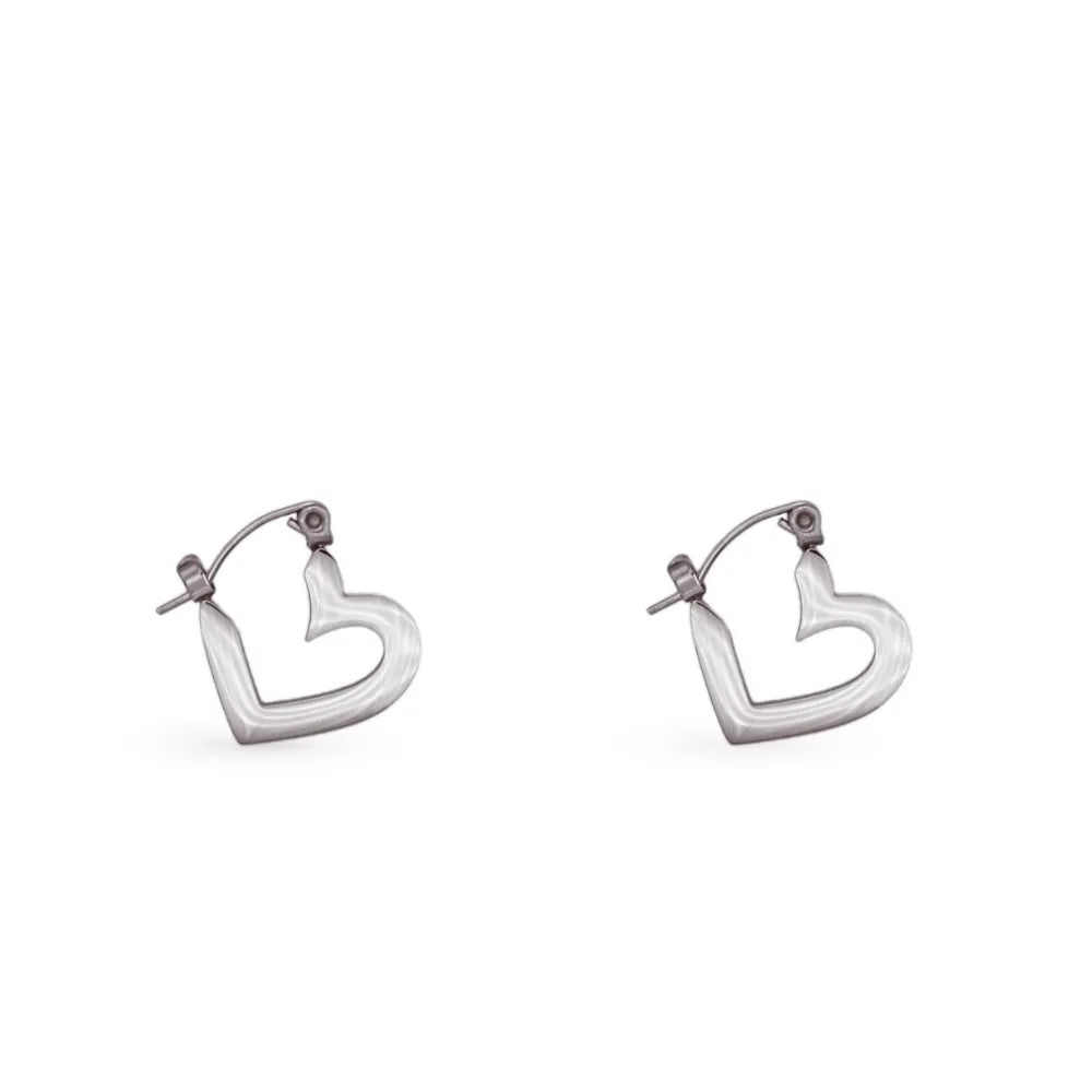 Polished heart-shaped hoops – balancing emotion, clarity, and connection.