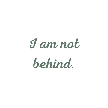 Calming affirmation graphic with the phrase “I am not behind” in green script font on a clean white background.
