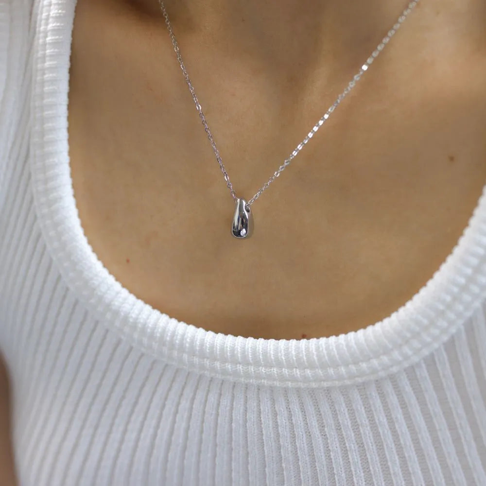 Teardrop silver pendant necklace – representing stillness, emotion, and reflection.