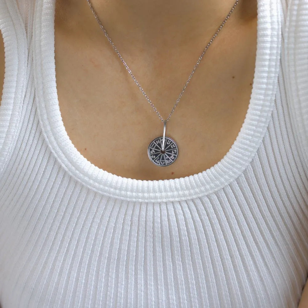 Engraved disc pendant featuring a starburst – designed to channel inner radiance.