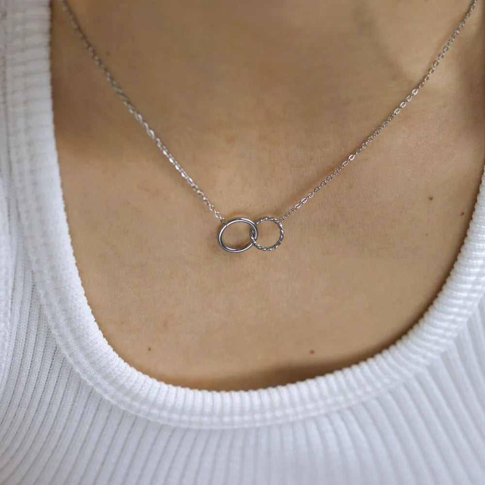 Interlocking circle pendant necklace – minimal expression of unity and resilience.