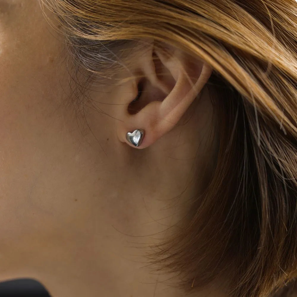 Polished heart-shaped stud earrings – celebrating connection, softness, and sincerity.